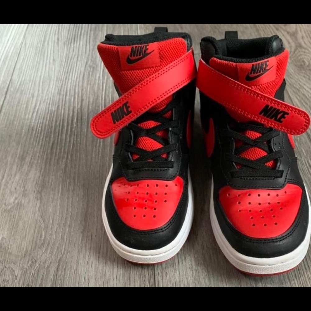 Kids black and red Nike shoes